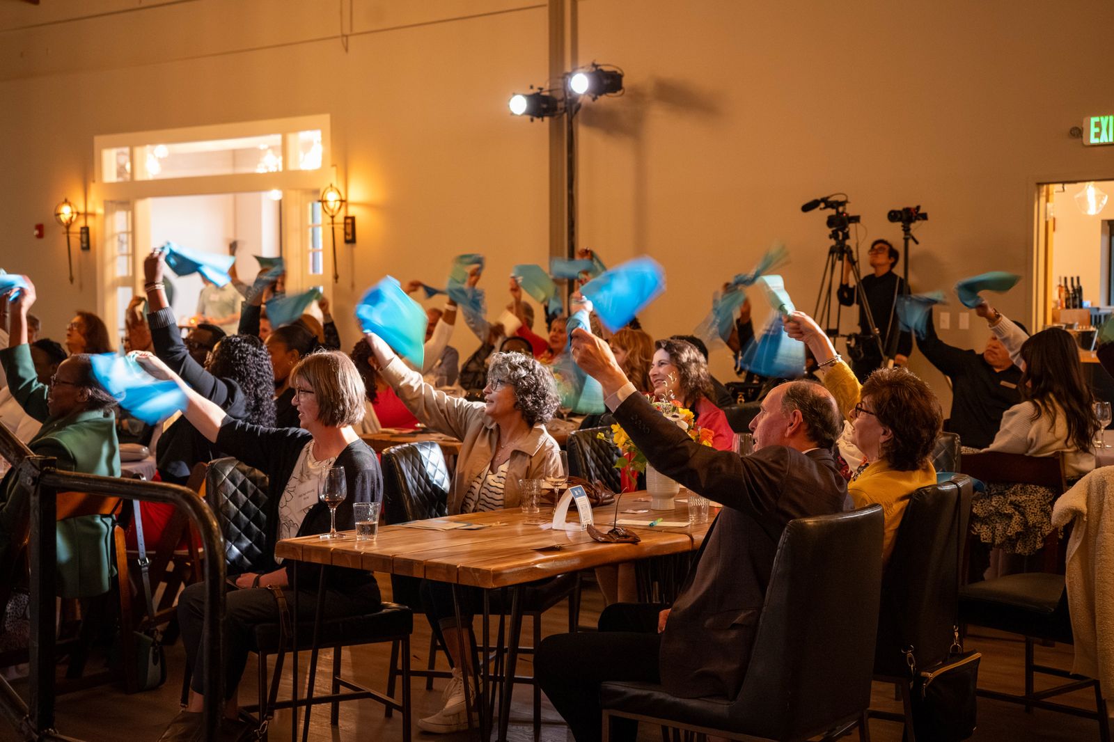 Guests raising paddles during the Friends of Youth gala