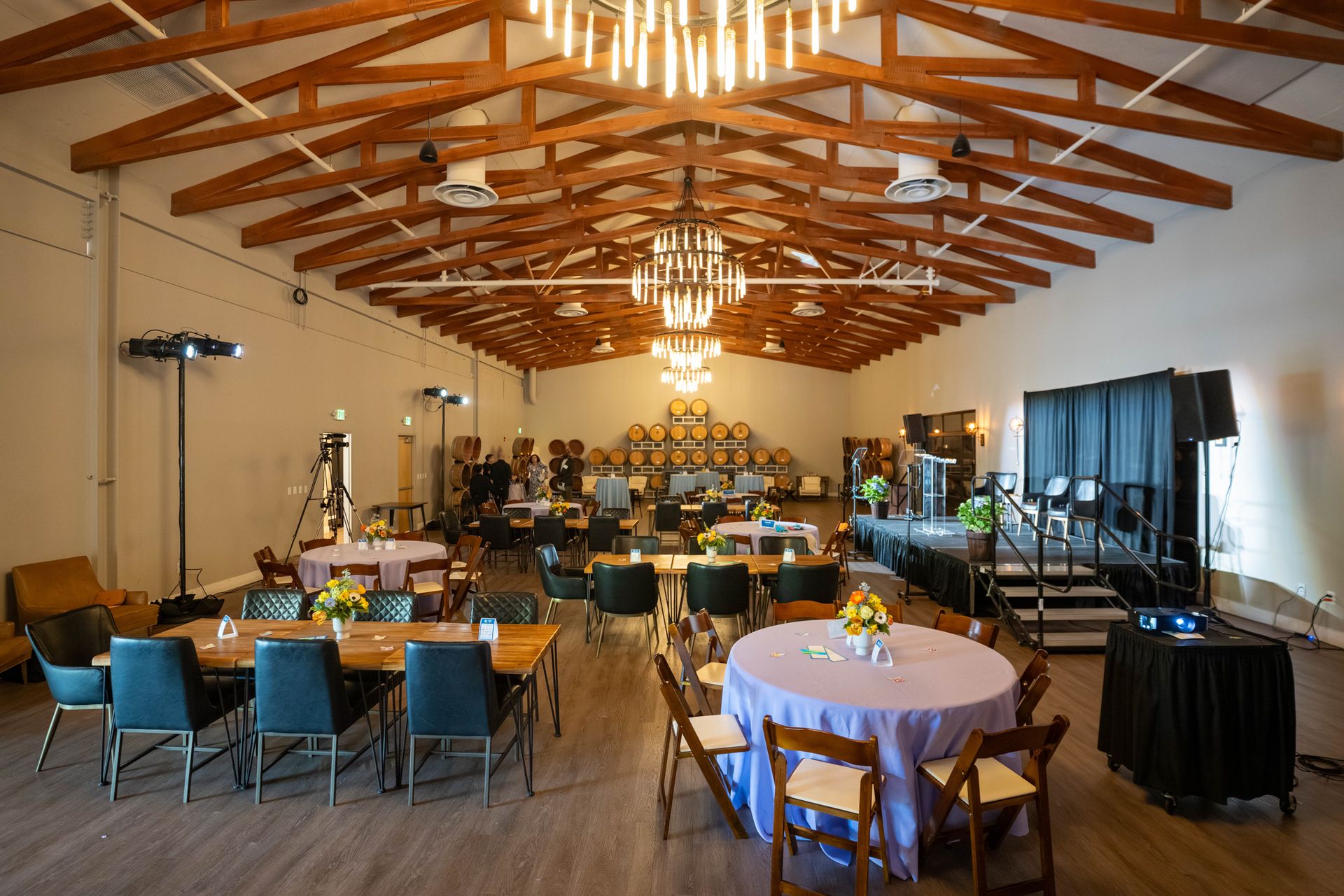 A ballroom set for a gala with round tables and chandeliers