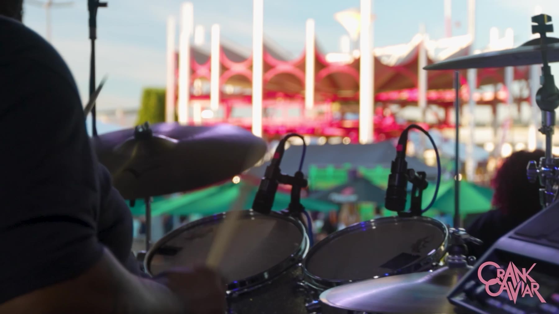 View from behind a drum kit on an outdoor stage